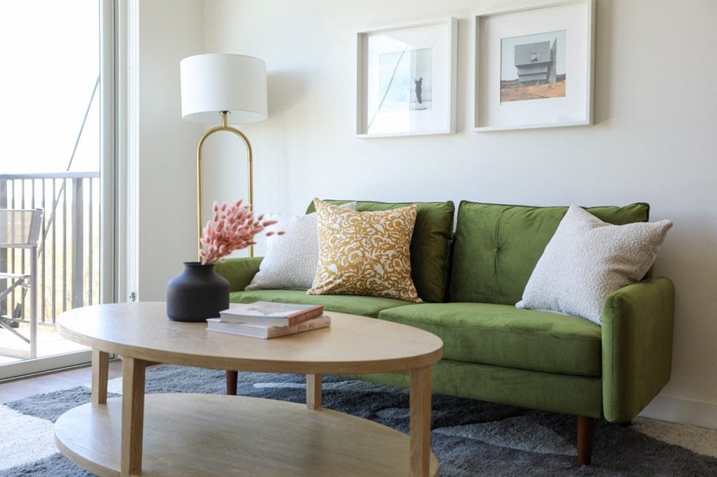 a living room with a green couch and a coffee table