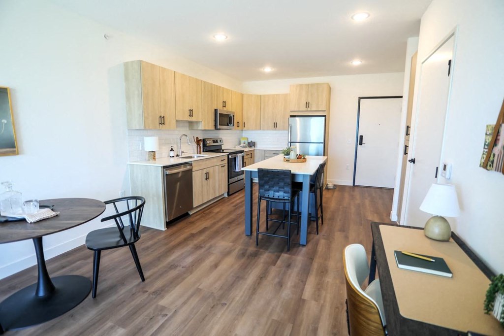 a kitchen and dining area with a table and chairs