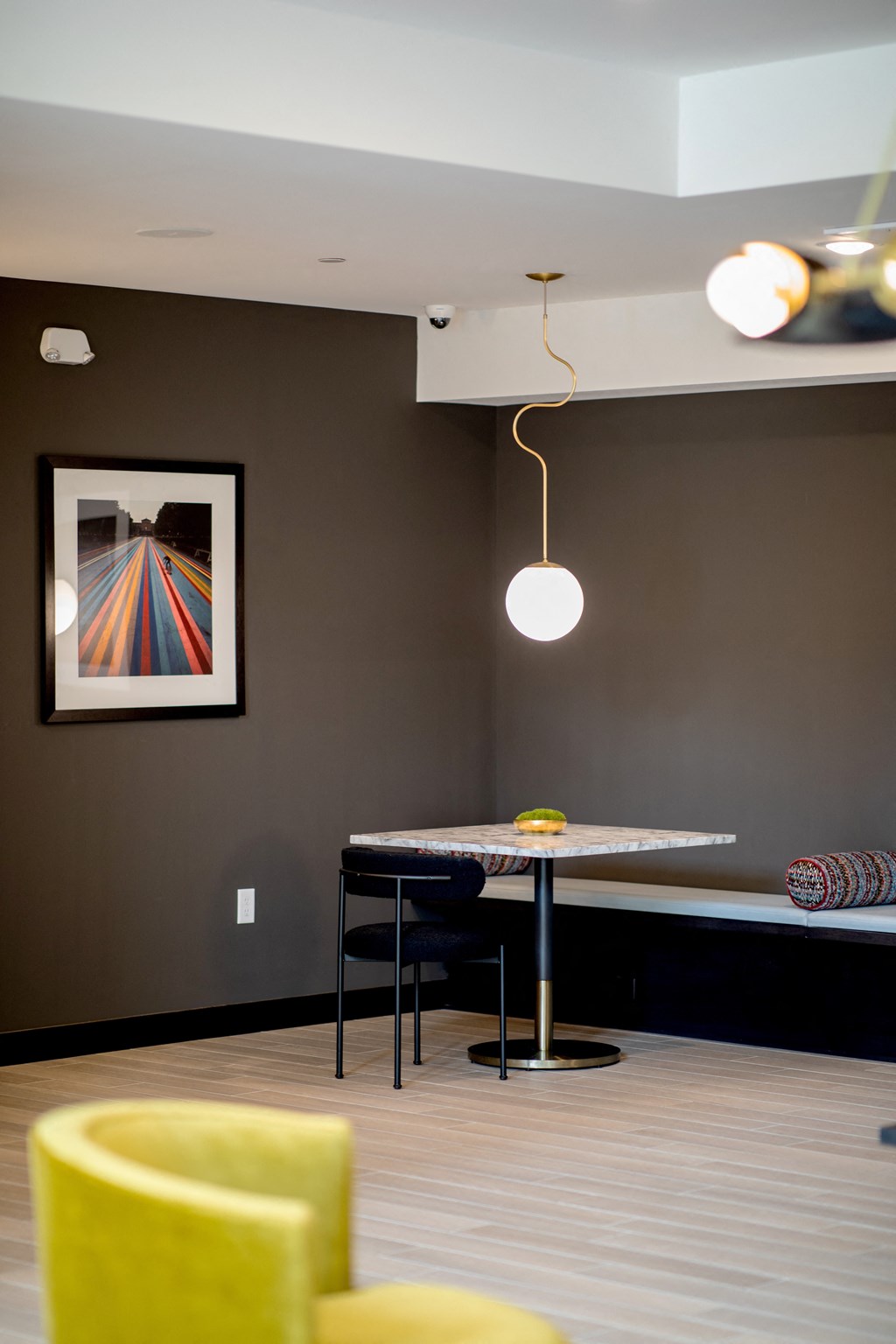 a dining room with a table and chairs and a picture on the wall