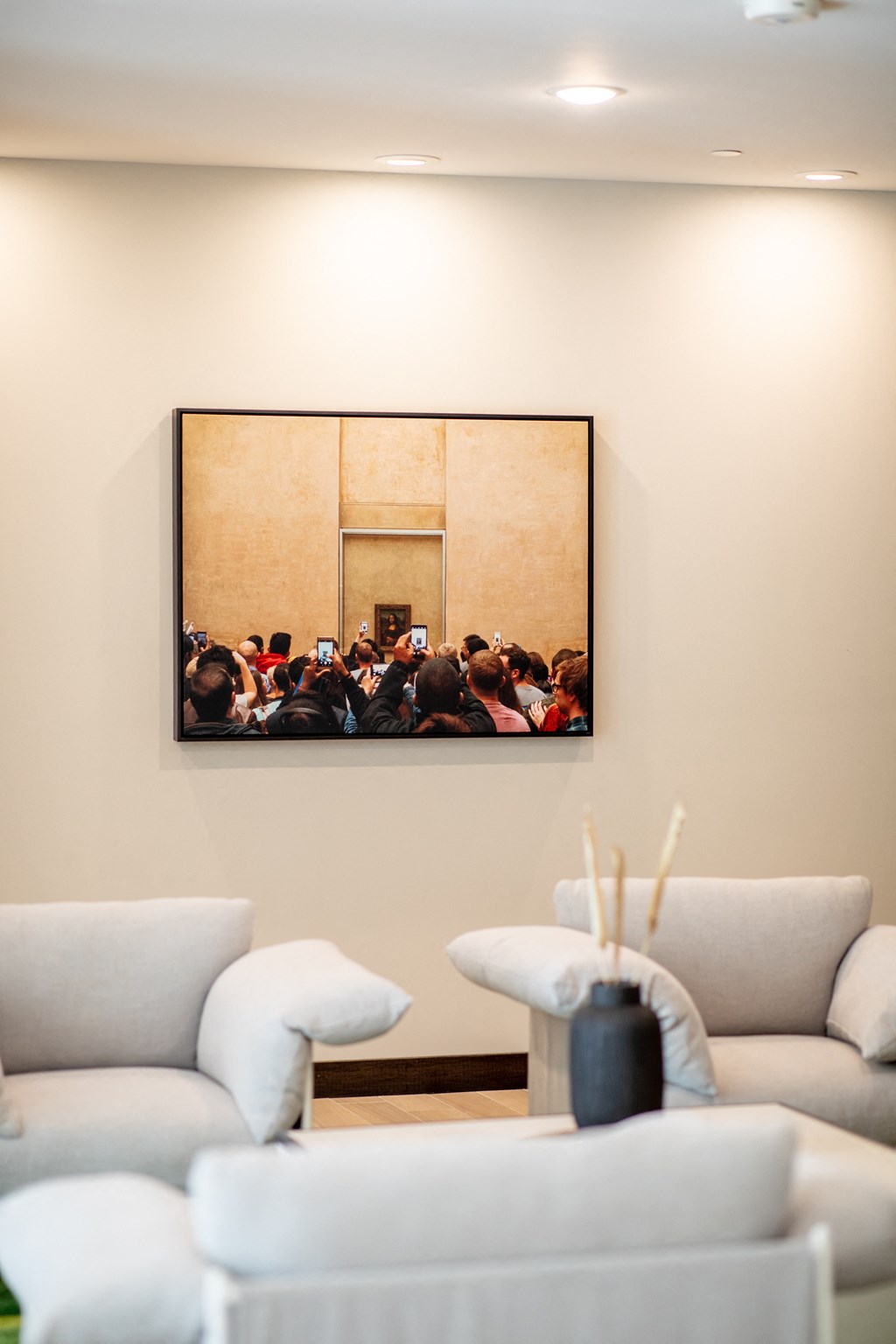 a painting of a group of people on a wall in a living room