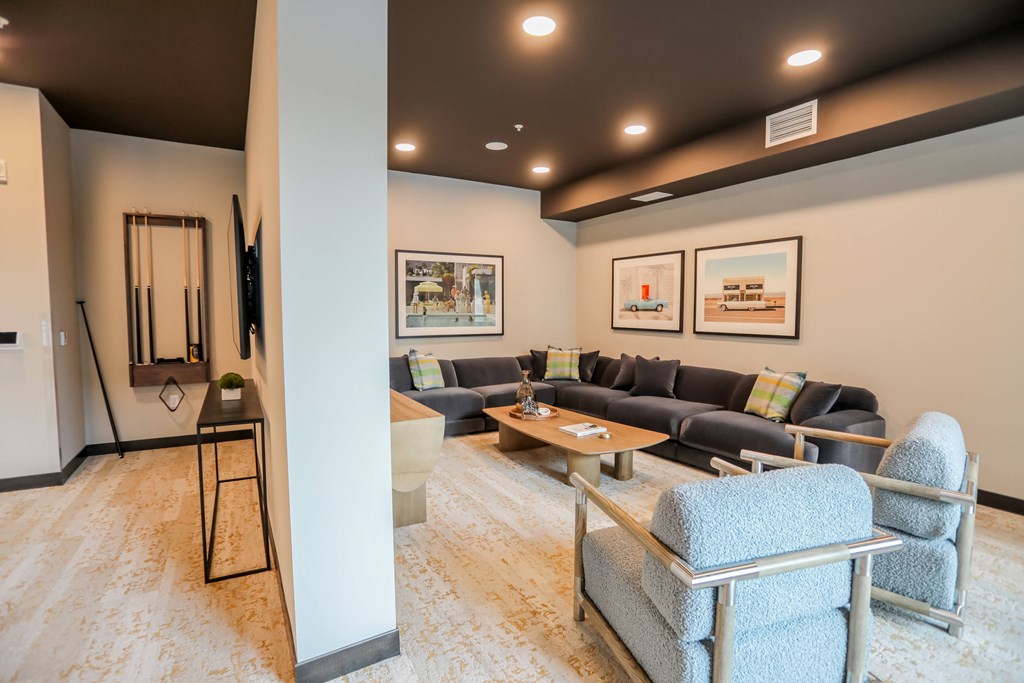 a living room with couches and chairs and a table