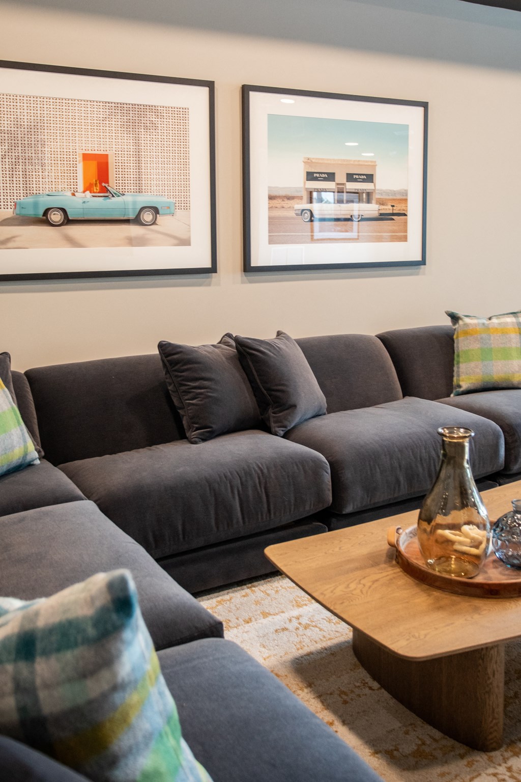 a living room with couches and pictures on the wall