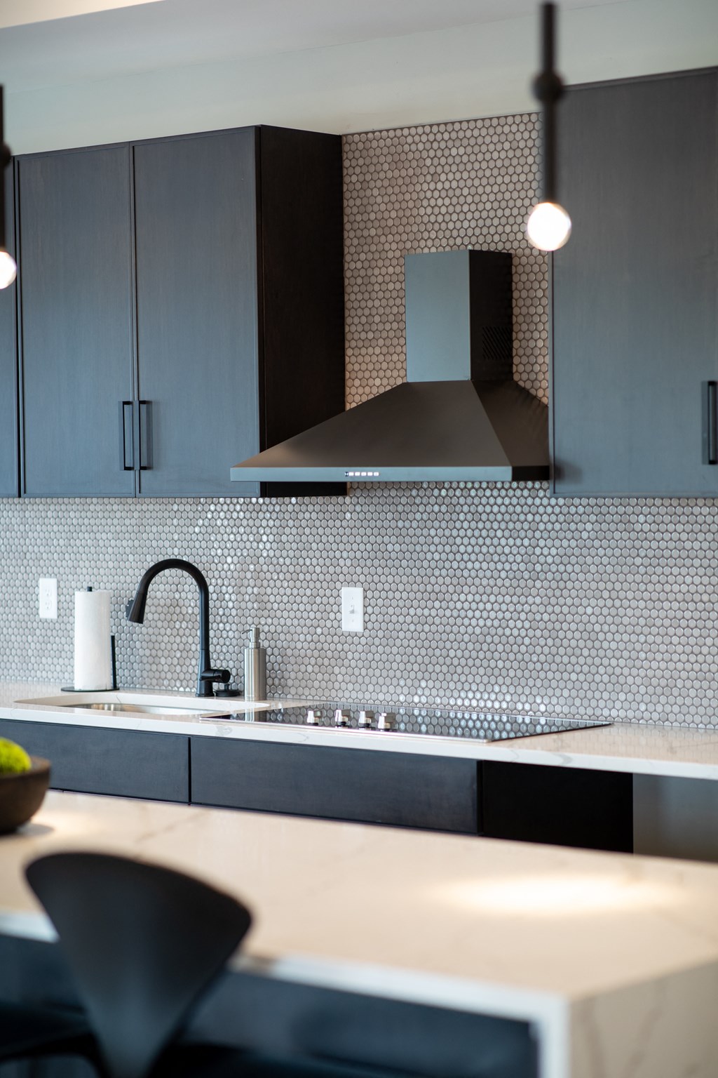 a kitchen with white counter tops and a sink