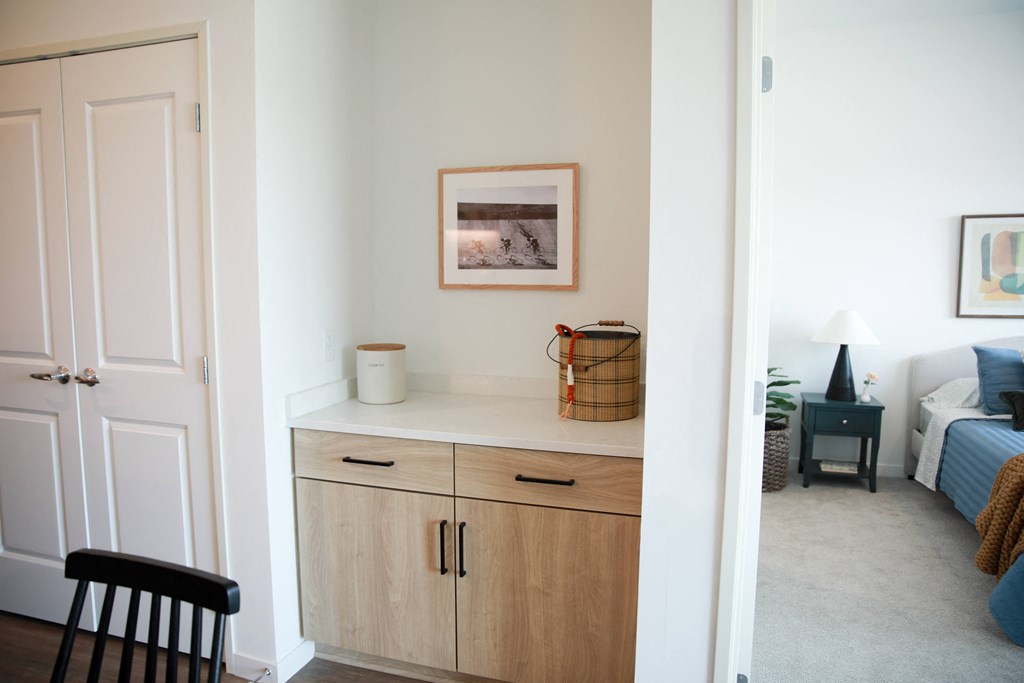 a living room with a counter and a bedroom with a bed