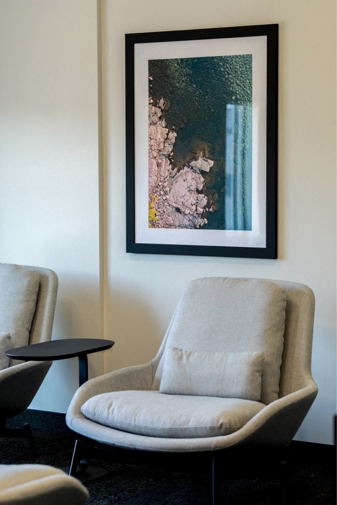 a chair and a picture on a wall in a room