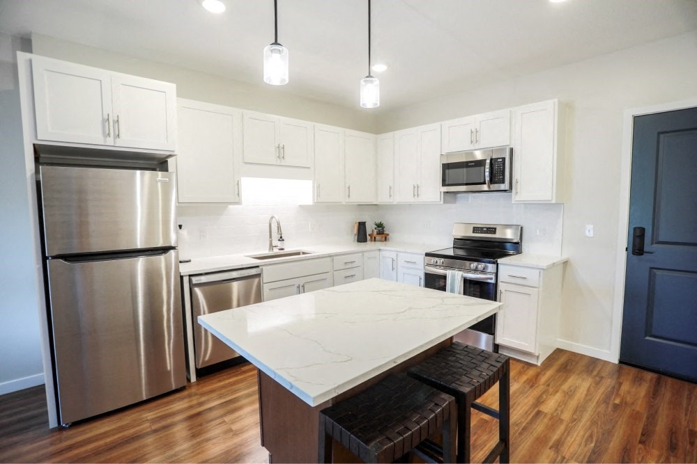 a kitchen with stainless steel appliances and a white counter top