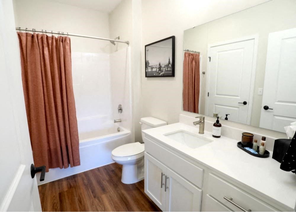 a bathroom with a white sink and a shower and a toilet