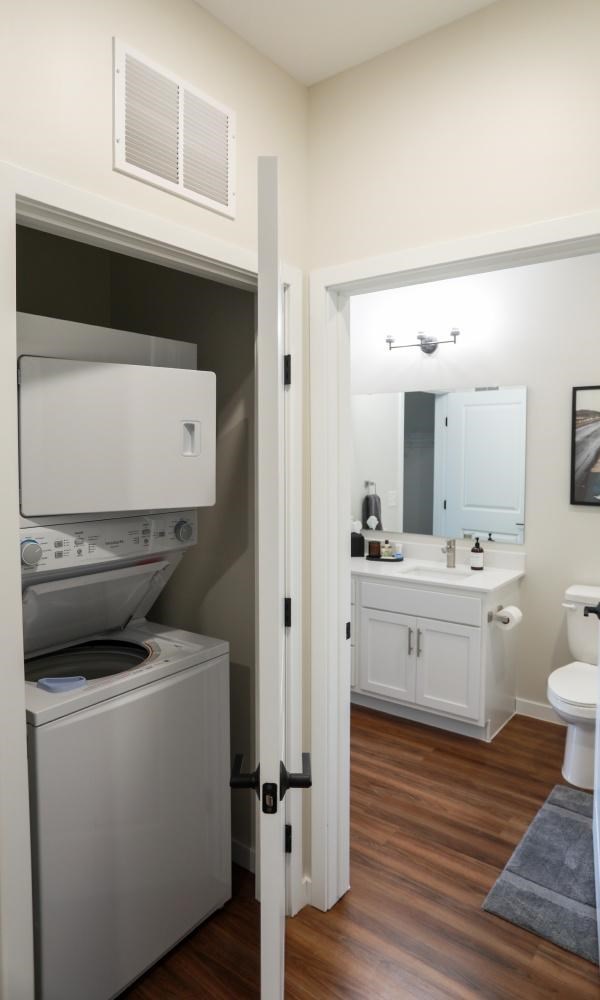 A white washing machine and dryer in a small laundry room.