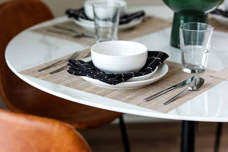 a white table with a bowl on top of it