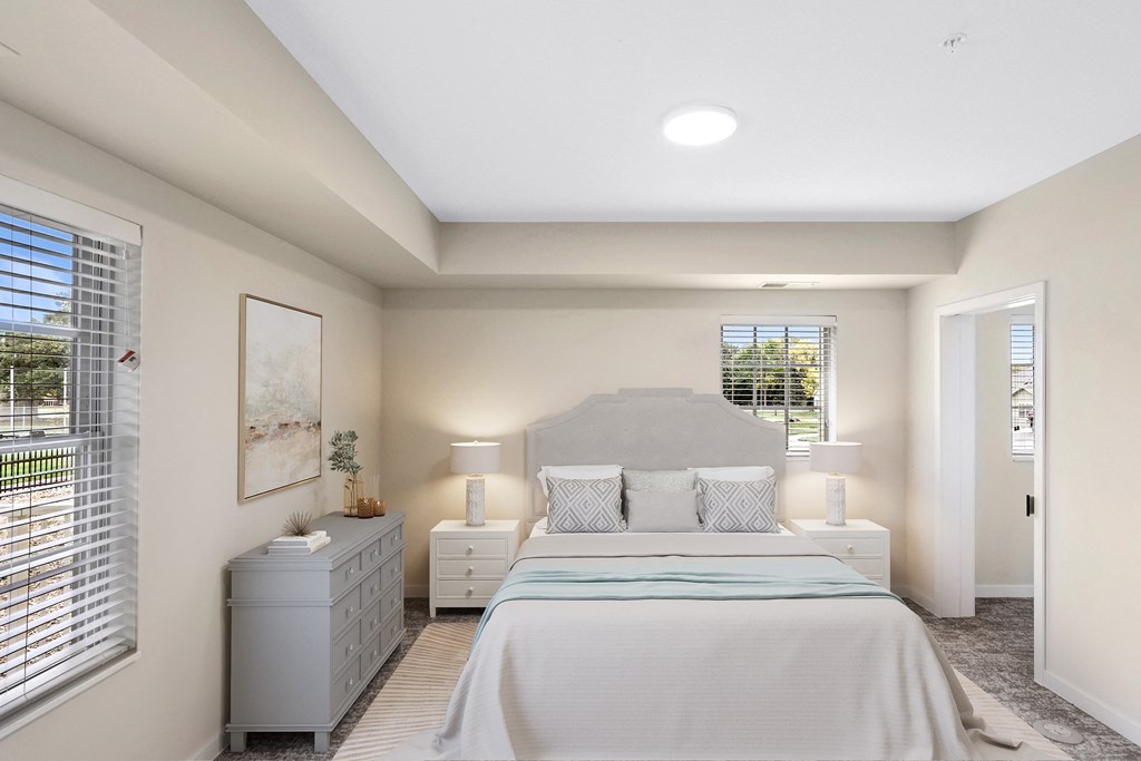 a white bedroom with a large bed and a window