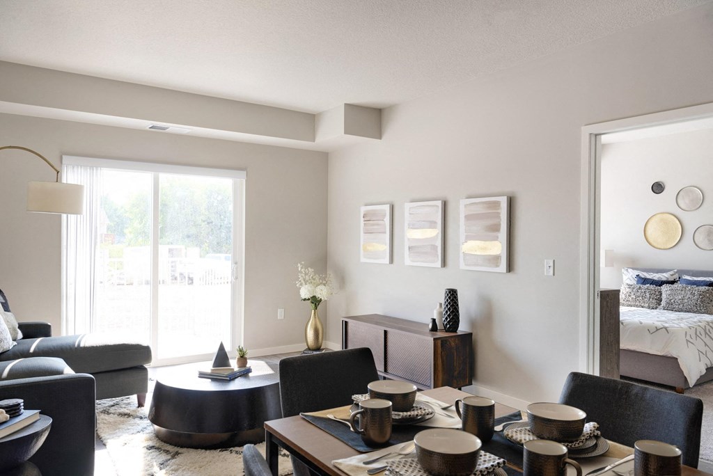 A modern living room with a dining table set for four.