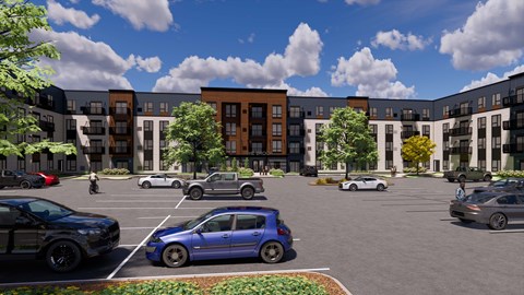 A blue car is parked in a parking lot in front of apartment buildings.