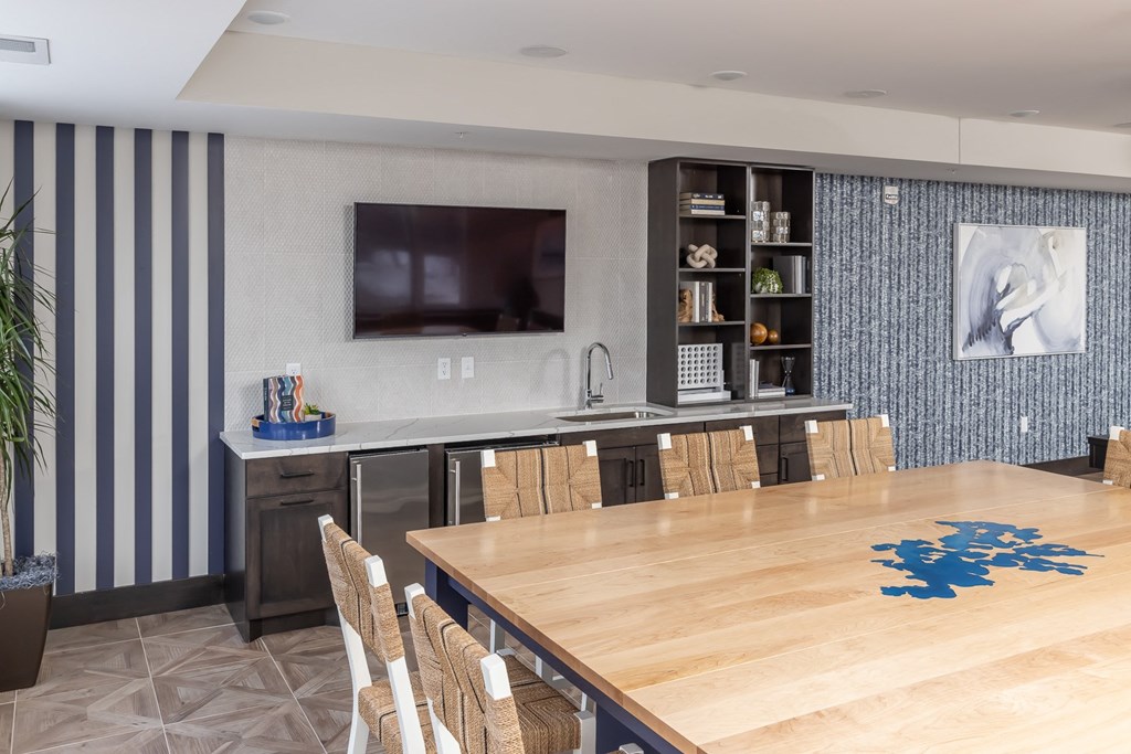 a dining room with a table and chairs and a tv