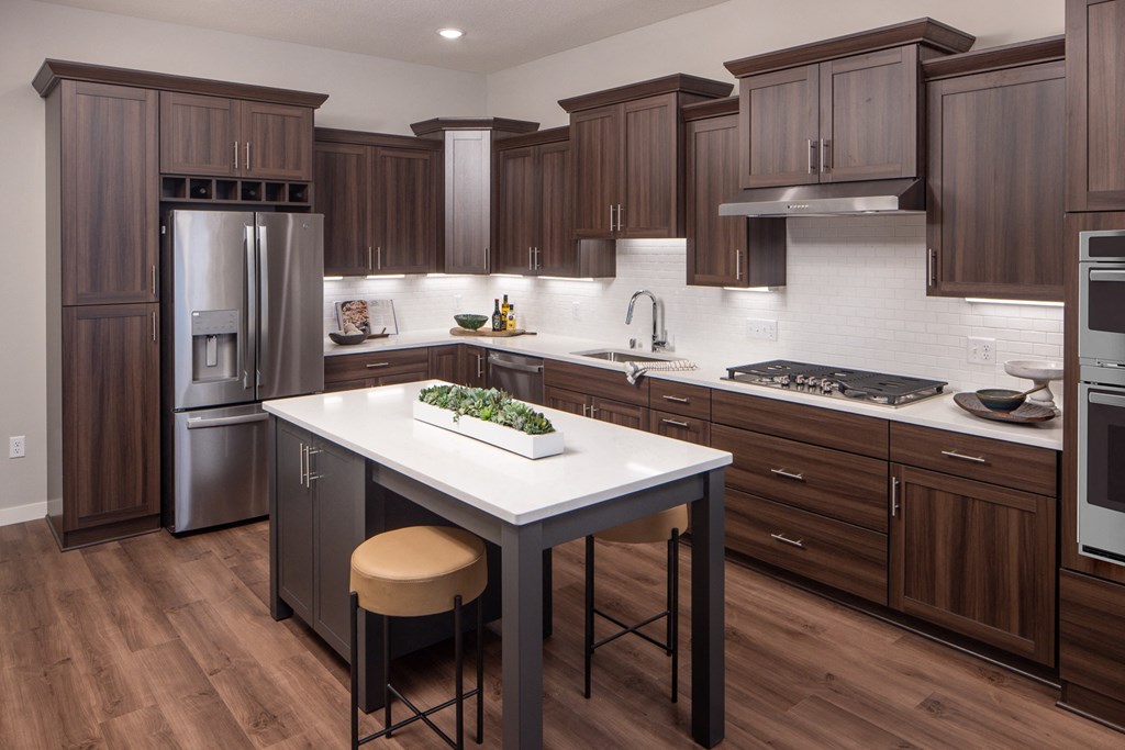 Townhome kitchen with brown cabinets and large center island