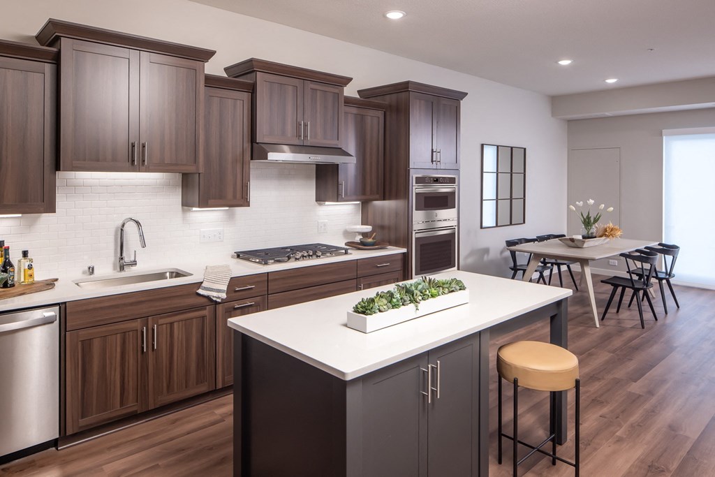 Townhome kitchen with brown cabinets and large center island