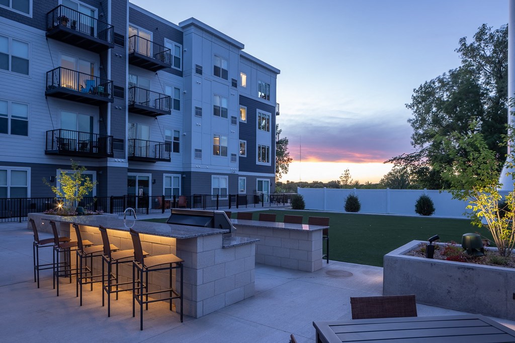 a rendering of an apartment building with a patio and a fire pit