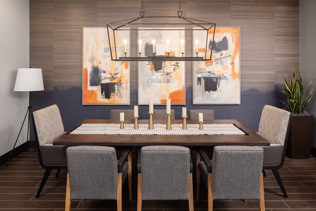 a dining room with a wooden table and chairs