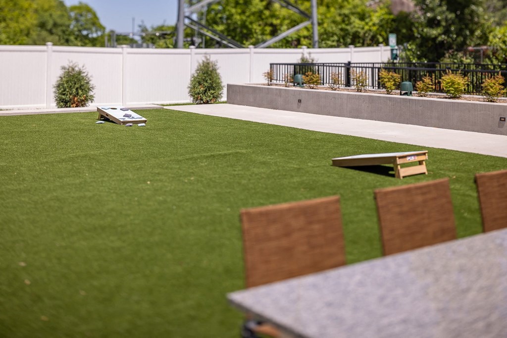 a lawn with chairs and a picnic table on it