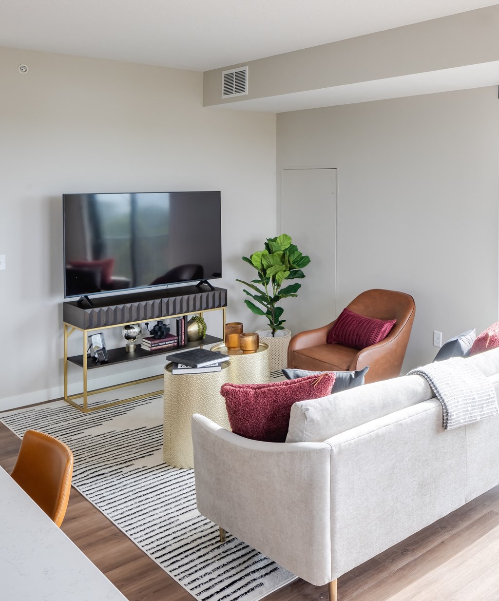 a living room with a couch and chairs and a television