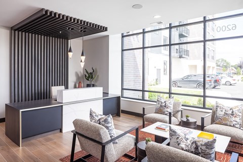 a hotel lobby with couches and chairs and a reception desk