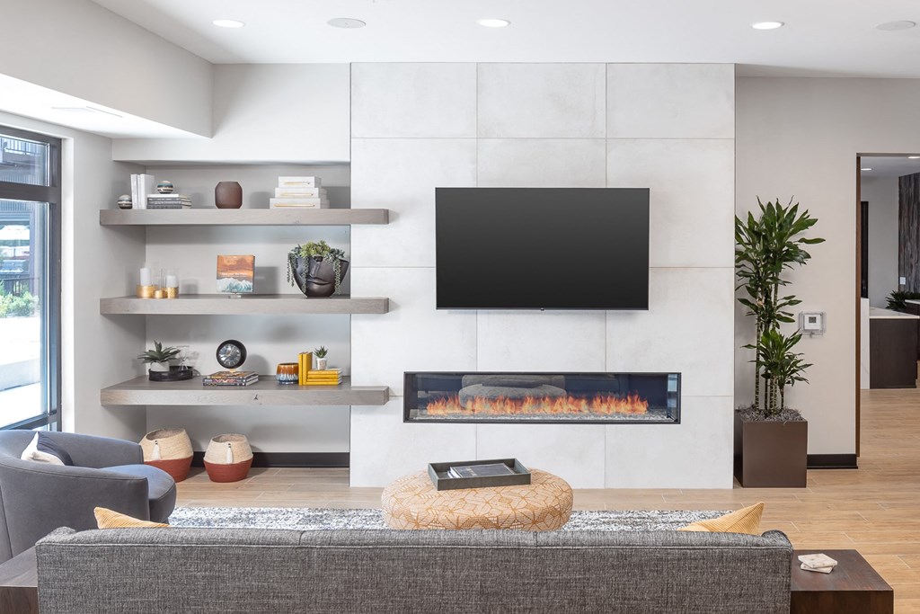 a living room with a fireplace and a television