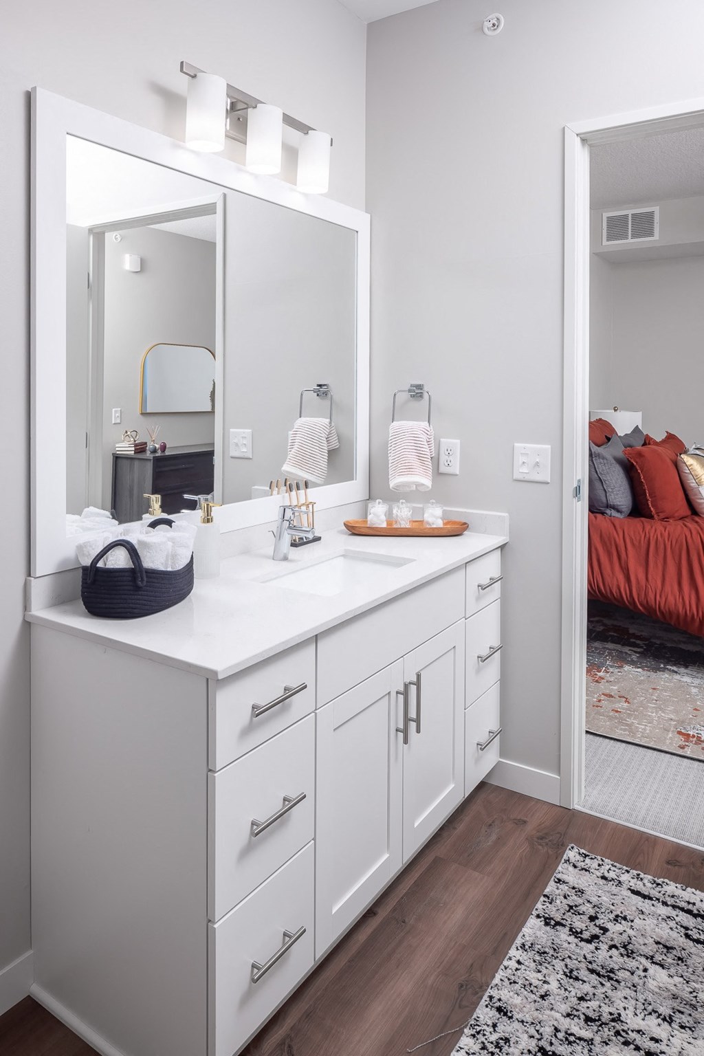 a white bathroom with a large mirror and a sink