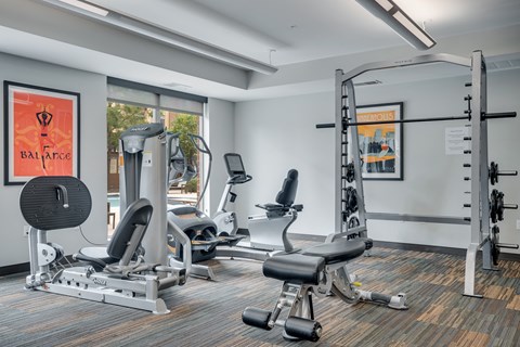 a gym with treadmills and other exercise equipment in a building