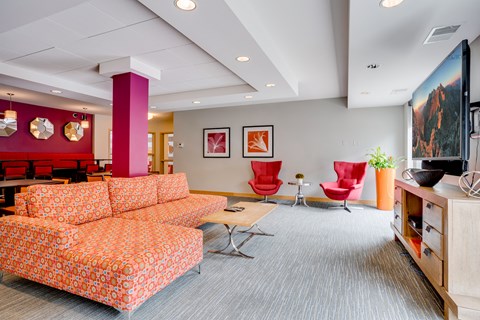 a living room with couches and chairs and a television