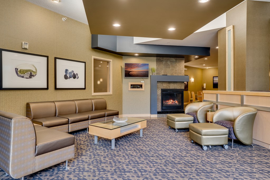 a living room with couches and chairs and a fireplace