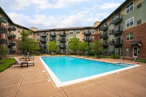 a swimming pool in front of an apartment building