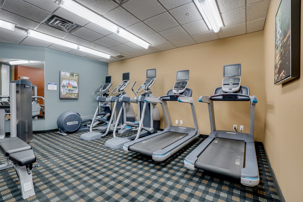 a gym with cardio equipment and exercise machines