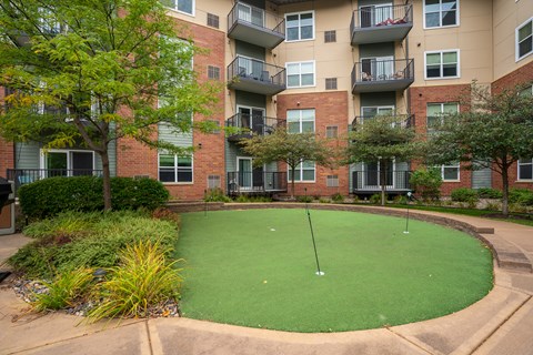a putting green in front of an apartment building