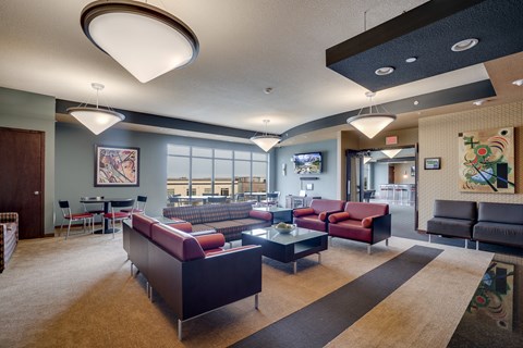 a large lobby with couches and chairs and a table