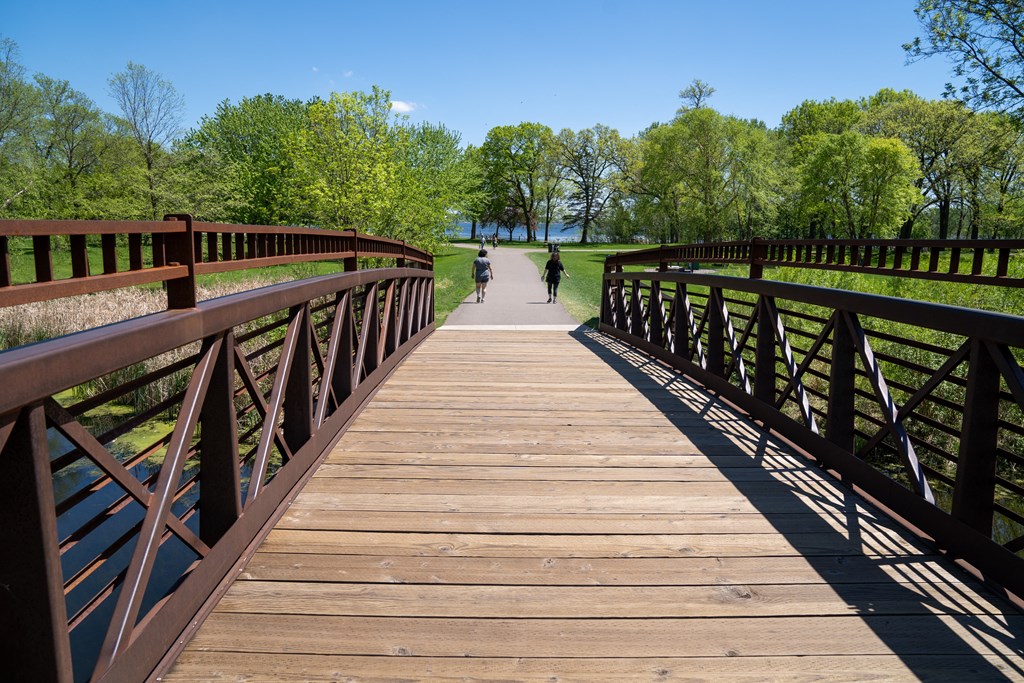a bridge over a body of water with people walking on it