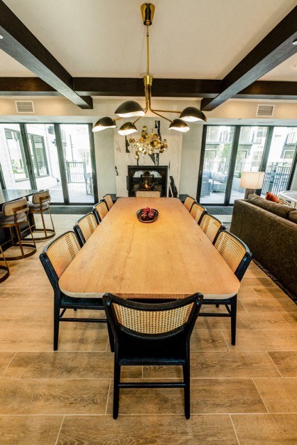 a large wooden table with chairs in a living room