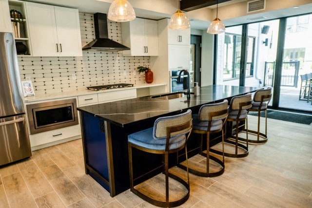a view of a kitchen with a bunch of counters and chairs