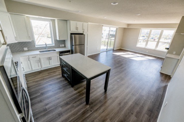 an empty kitchen and living room with a table