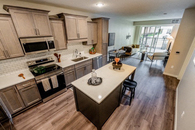 a large kitchen with a center island and a living room