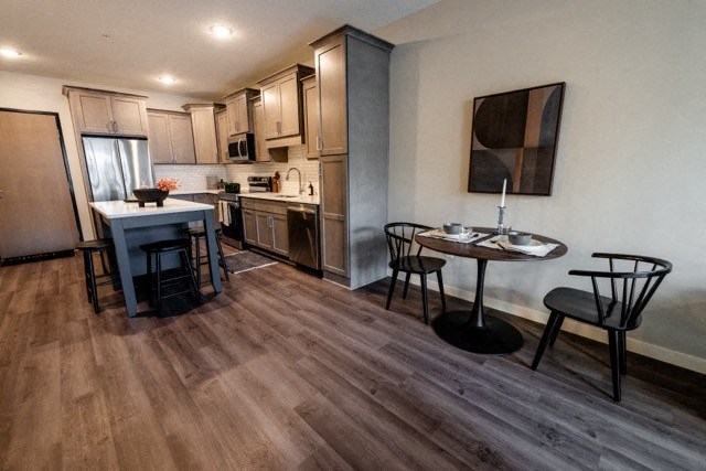 a kitchen and dining room with a table and chairs