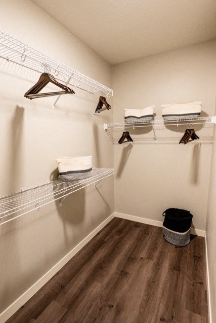 a walk in closet with shelves and racks