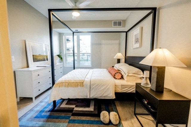 a bedroom with a large bed and a large mirror