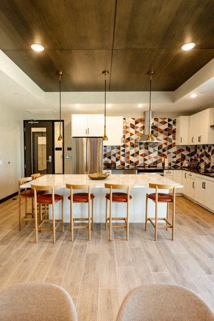 a kitchen with a large island and a dining table