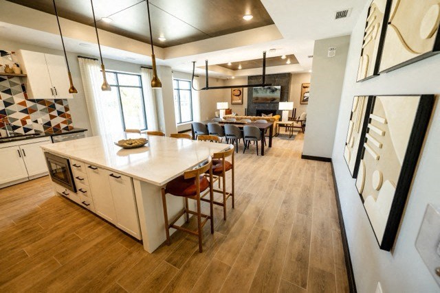 a large kitchen and dining room with a table and chairs