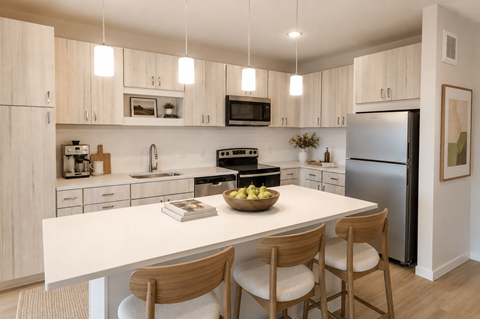 A modern kitchen with a white table and wooden chairs.