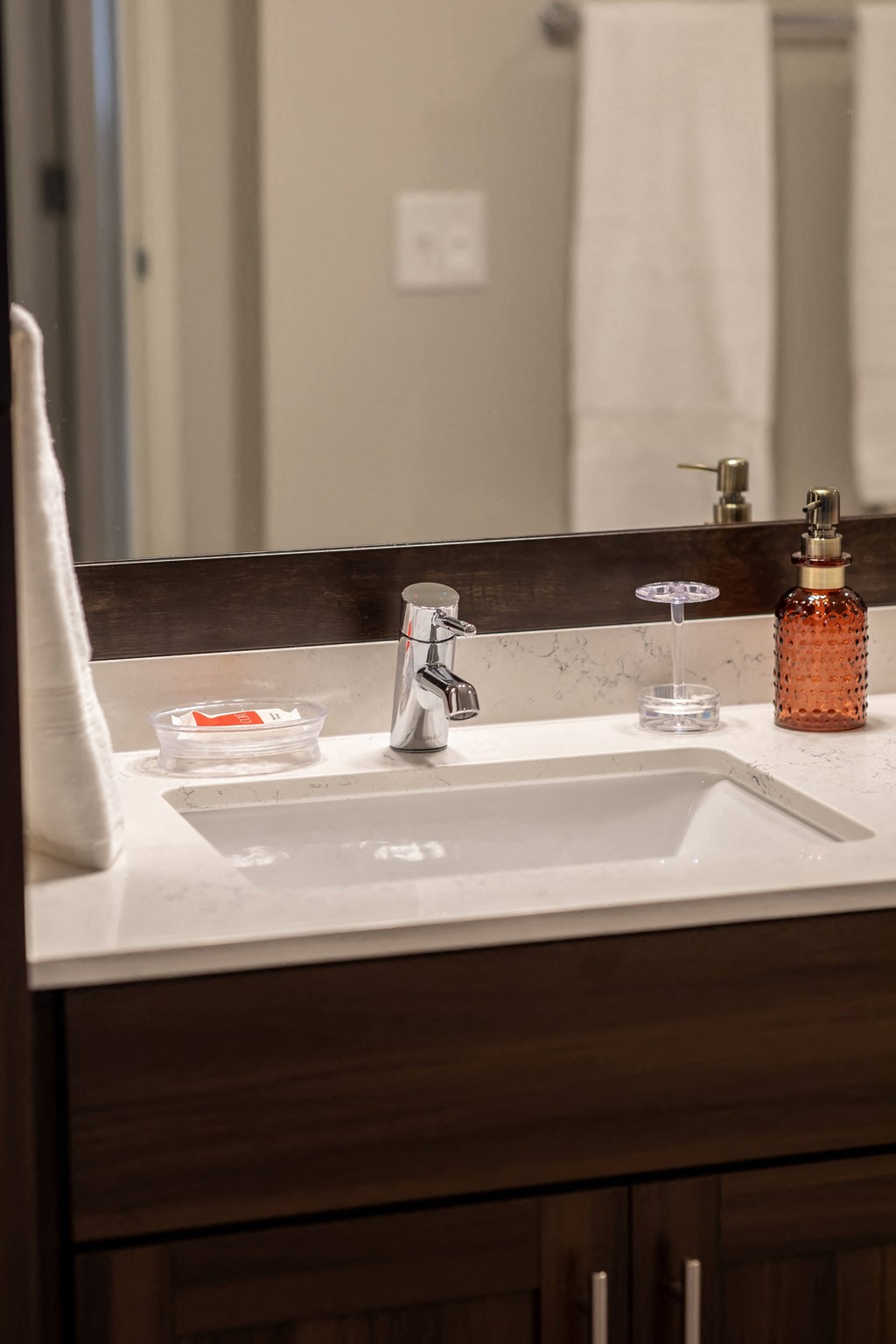 a bathroom sink with a mirror and a towel on it