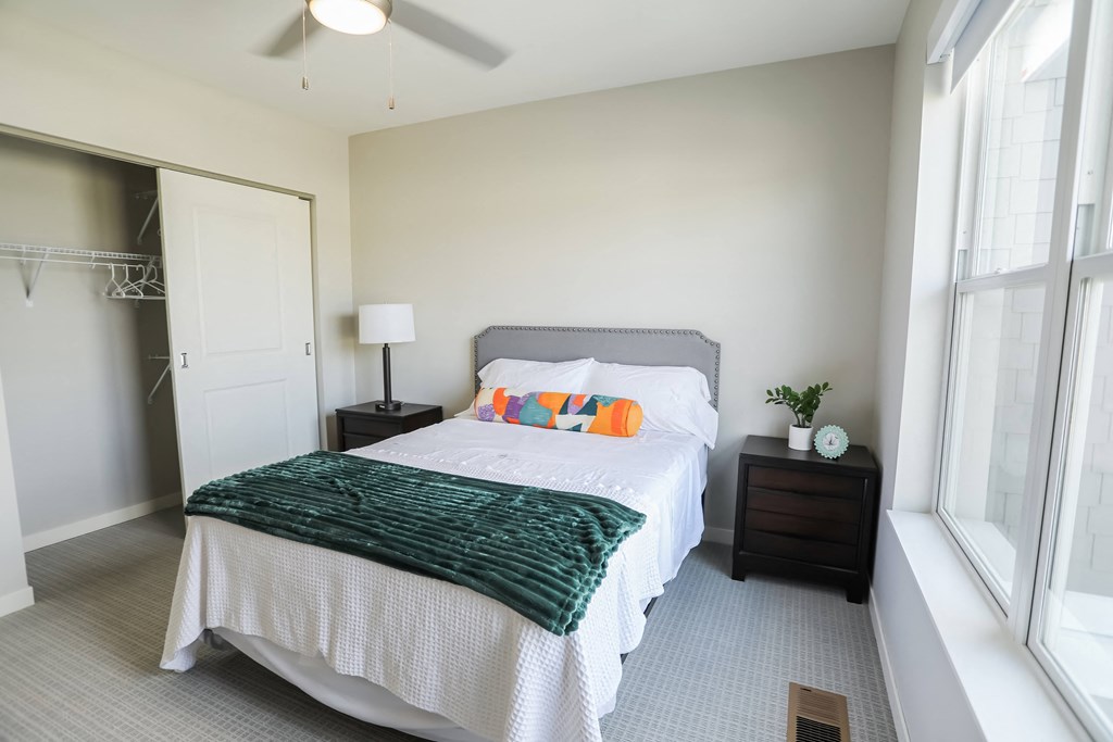 a bedroom with a large bed and a window
