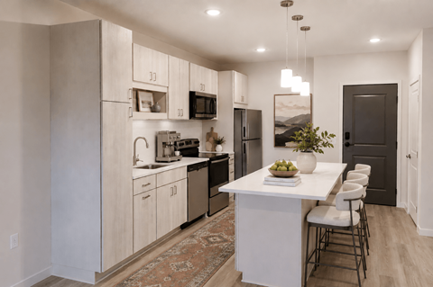 A kitchen with a white island and a rug on the floor.