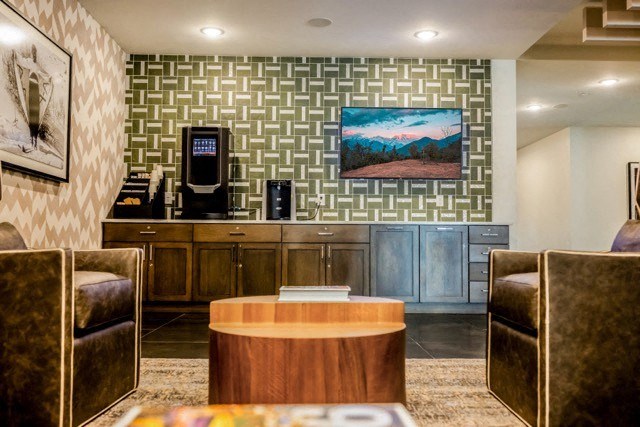 a lobby of a hotel with a coffee table and chairs