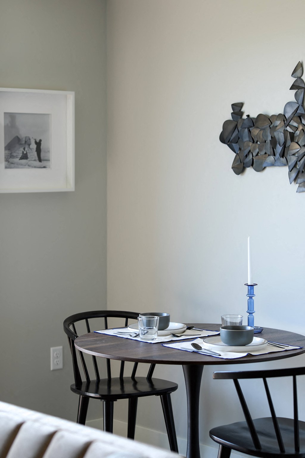 a dining room with a table and chairs and a candle