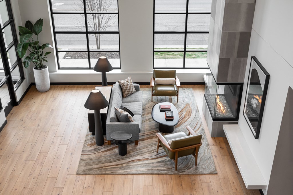 a living room with a couch and chairs on a rug